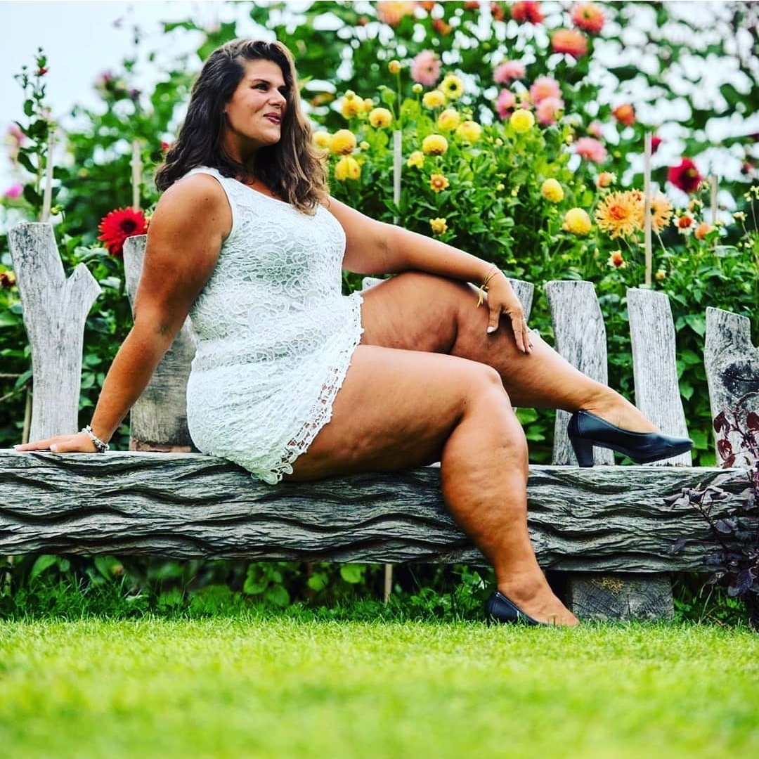 Bloggerin Kathy posiert outdoor auf einer Bank und zeigt ihre nackten Beine